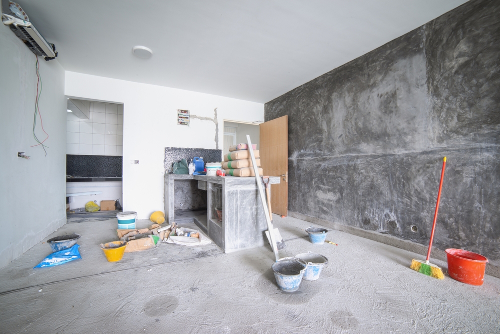 Building materials and tools scattered on floor during apartment renovation