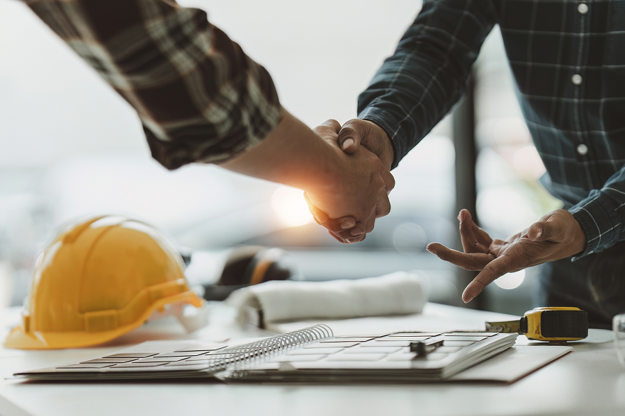 Handshake over Construction Plans