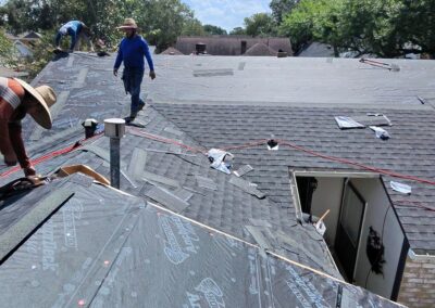 Crew Installing New Shingles on a Katy Roof
