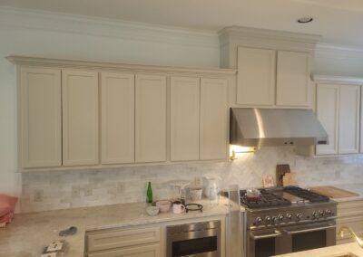 Professional Range with Custom Hood and Cream Cabinetry