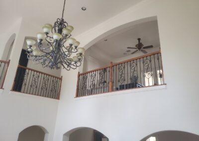 Two story Foyer with Chandelier and Iron Balcony Rail