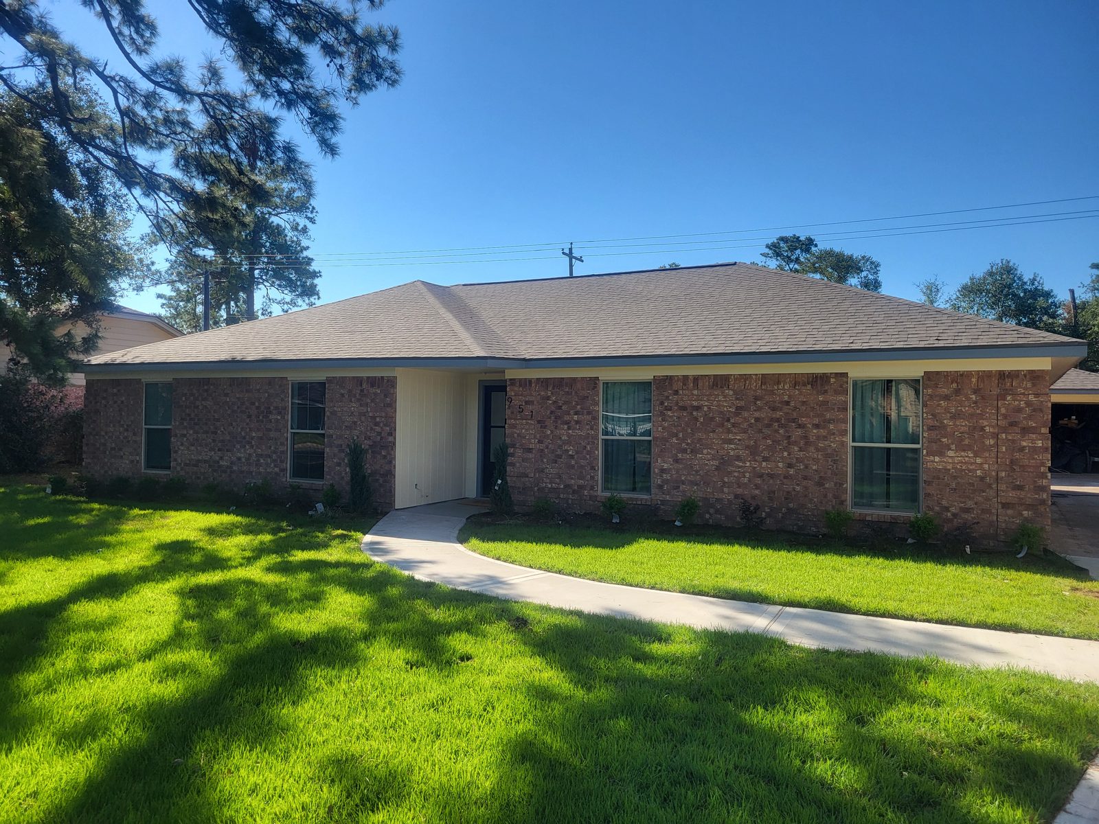 Renovated Brick Home Exterior with Fresh Landscaping Houston Heights Area